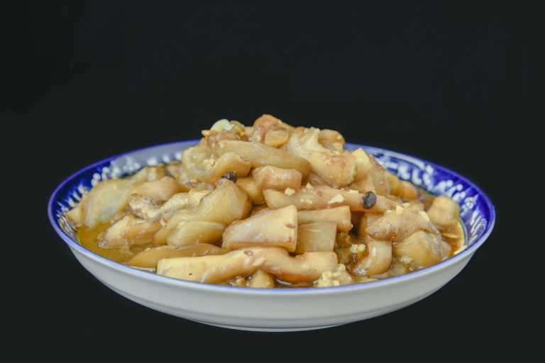 A flavorful Chinese stir fry served in a traditional blue patterned bowl.